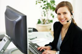 Woman with phone headset at a computer